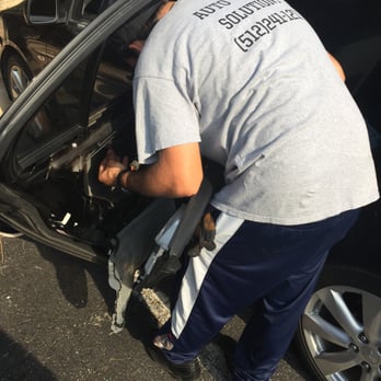 Auto Glass Solutions - Austin, TX, United States. Mobile Window installation technician (Dimitrios) working hard.