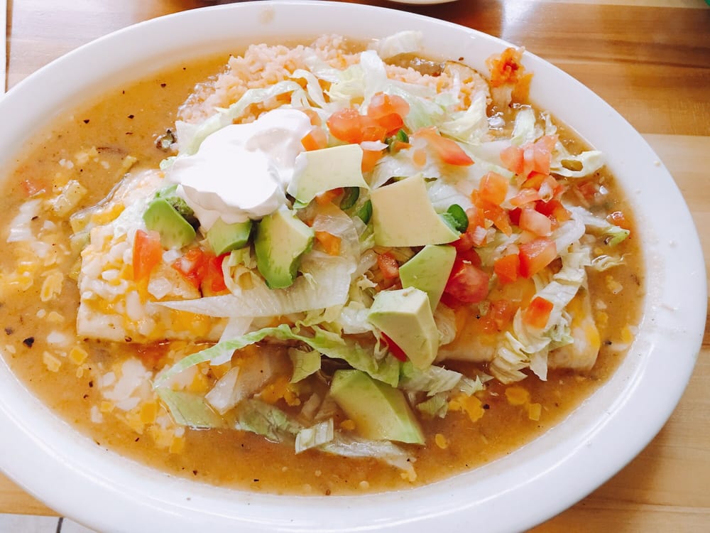 Taqueria La Familia - Denver, CO, United States. HUGE burrito with all kinds of yummy goodness on top.
