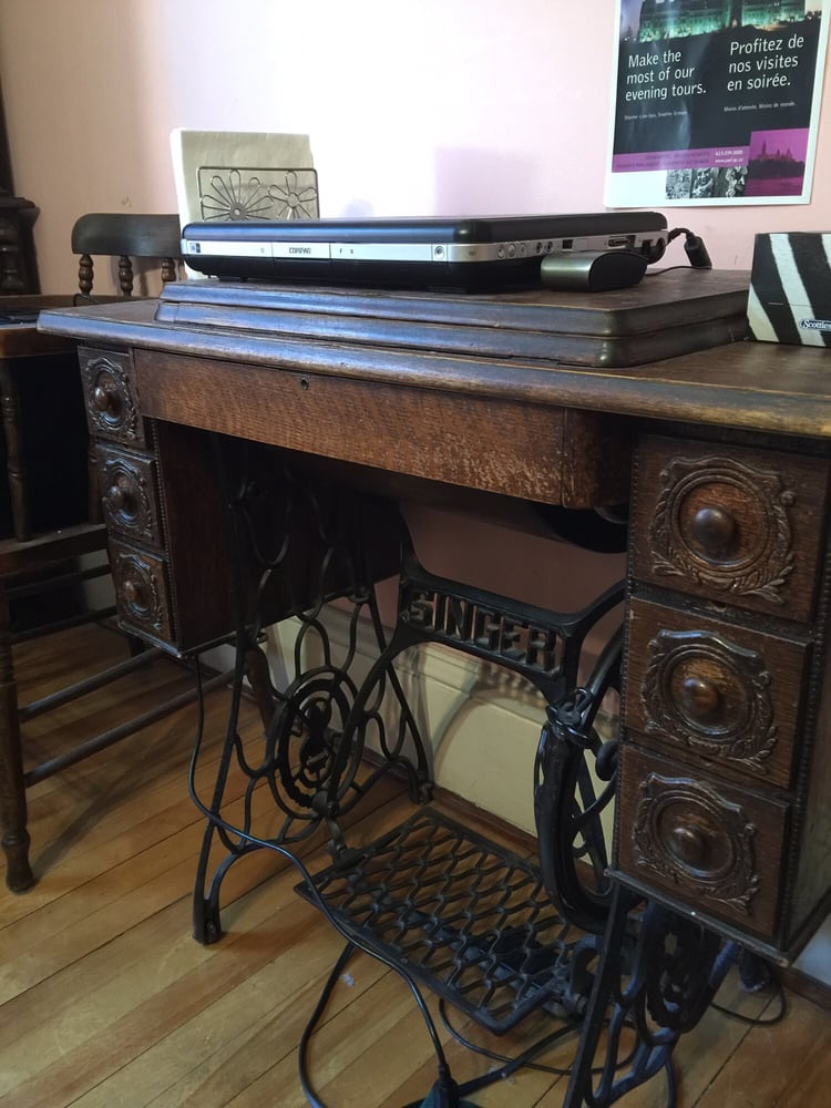Used As A Computer Desk Is An Antique Singer Sewing Machine