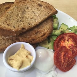 Photo of Le Croissant D'Or - Dublin, Republic of Ireland. Poached egg, roast tomato, avocado, hummus on toast.