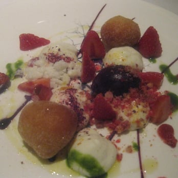 Whipped ewes milk yoghurt with wild strawberries, lemon verbena meringues and warm ctirus beignets.