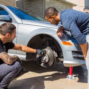 Photo of Fiix - Toronto, ON, Canada. Andrew showing Jahmal the different components of his brake system on his Mercedes.