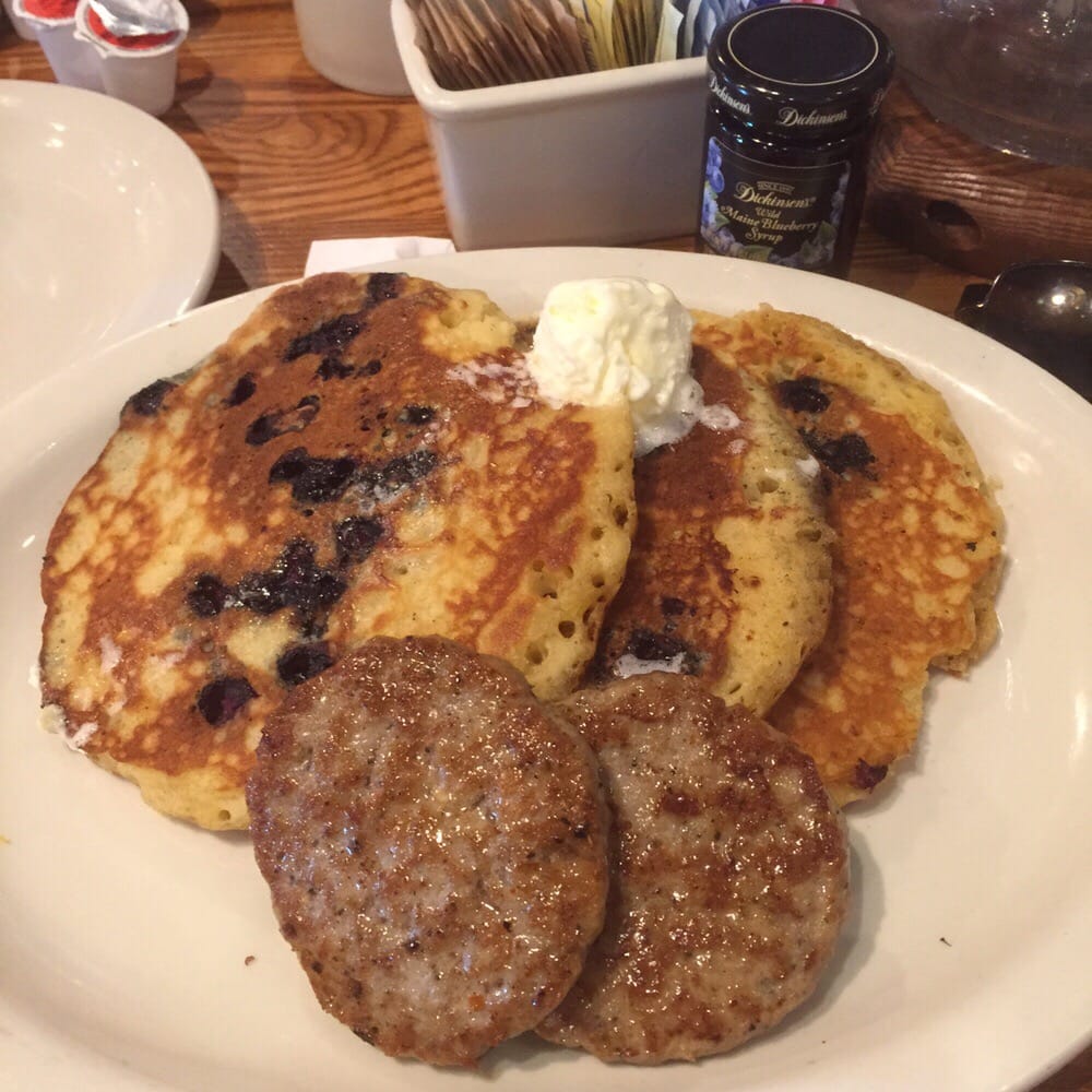 blueberry pancakes served with a jar of warm blueberry blueberry pancakes served with a jar of warm blueberry