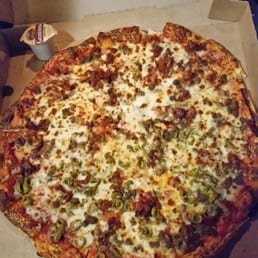 Memories Pizza - Walkerton, IN, United States. Taken outside at night, so a little dark. Bacon, Pork Sausage and half plus green olives.