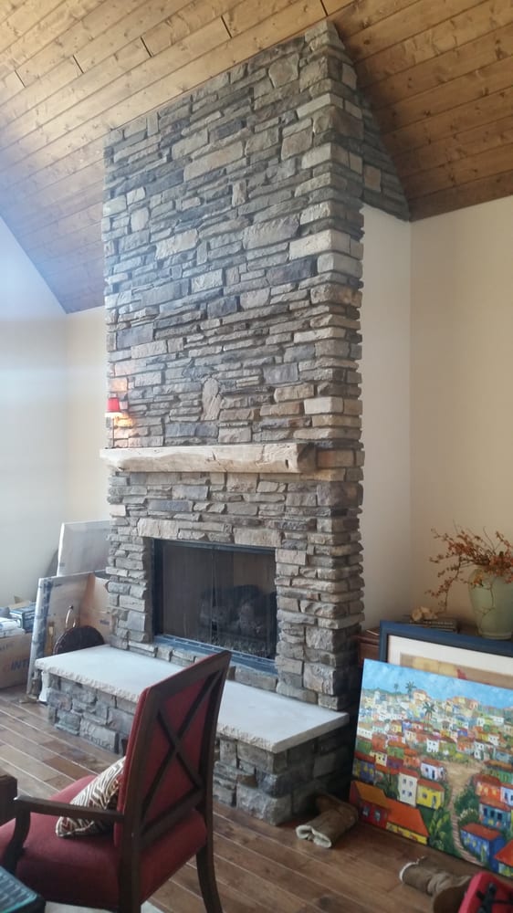 Fireplace done in Echo Ridge Country Ledgestone by Boral Cultured Stone with wood mantel and custom masonry fireplace doors. - Yelp Photo of Brighton Stone & Fireplace - "Fireplace done in Echo Ridge Country Ledgestone by Boral Cultured Stone with wood mantel and custom masonry fireplace doors." - Brighton